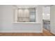 Kitchenette features stainless steel appliances, grey cabinets, white countertops, and a breakfast bar at 4010 W Watrous Ave, Tampa, FL 33629