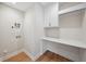 Laundry room featuring built-in desk space, storage cabinets, and utility connections at 4010 W Watrous Ave, Tampa, FL 33629