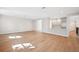 Open-concept living room features hardwood floors, white walls, and a bright kitchen space at 4010 W Watrous Ave, Tampa, FL 33629
