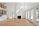 Sunlit living room with fireplace, wood floors, and doors leading to the backyard at 4010 W Watrous Ave, Tampa, FL 33629