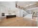 Bright open-concept living room with high ceilings, wood floors, island kitchen, and staircase to upper floors at 4010 W Watrous Ave, Tampa, FL 33629