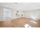 Spacious living room with hardwood floors, white walls, and access to a kitchenette at 4010 W Watrous Ave, Tampa, FL 33629
