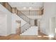 View of the staircase featuring wood and wrought iron railing with abundant natural light and beautiful architectural details at 4010 W Watrous Ave, Tampa, FL 33629