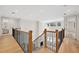 Upstairs view of the wood staircase with iron spindles and hardwood floors at 4010 W Watrous Ave, Tampa, FL 33629