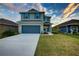 Two-story house with gray siding, blue door, and attached garage at 16111 69Th E Ln, Parrish, FL 34219