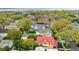 An aerial shot showcasing a neighborhood with a house featuring a red tile roof and a pool at 704 S Newport Ave, Tampa, FL 33606