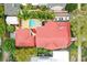 Overhead view of a house with red tile roof, pool, and lush landscaping at 704 S Newport Ave, Tampa, FL 33606