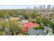 Aerial view of a charming house with red tile roof, surrounded by lush greenery and other homes at 704 S Newport Ave, Tampa, FL 33606