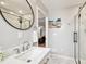 Clean bathroom with single vanity, large mirror, and walk-in shower at 704 S Newport Ave, Tampa, FL 33606