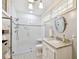 Modern bathroom with white subway tile, glass shower, and marble vanity at 704 S Newport Ave, Tampa, FL 33606