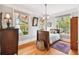 Bedroom with hardwood floors, large windows, and antique wood furniture at 704 S Newport Ave, Tampa, FL 33606