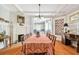 Bright dining room with hardwood floors, large table, and built-in shelving at 704 S Newport Ave, Tampa, FL 33606