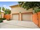 Two-car garage with orange accents and a wooden gate at 704 S Newport Ave, Tampa, FL 33606