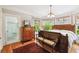 Main bedroom with hardwood floors, large windows, and antique furniture at 704 S Newport Ave, Tampa, FL 33606