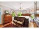 Main bedroom with hardwood floors, large windows, and antique furniture at 704 S Newport Ave, Tampa, FL 33606