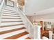 Elegant staircase with white railings and rich wood steps at 704 S Newport Ave, Tampa, FL 33606