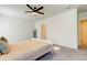 Main bedroom with ceiling fan and ensuite bathroom access at 7516 Cypress Walk Dr, New Port Richey, FL 34655