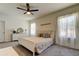 Main bedroom with ceiling fan and plush carpet at 7516 Cypress Walk Dr, New Port Richey, FL 34655