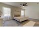 Main bedroom with ceiling fan, carpet flooring, and large windows at 7516 Cypress Walk Dr, New Port Richey, FL 34655