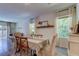 Spacious dining area with a farmhouse table and natural light at 7516 Cypress Walk Dr, New Port Richey, FL 34655