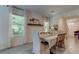 Dining room with farmhouse table, electric fireplace, and natural light at 7516 Cypress Walk Dr, New Port Richey, FL 34655