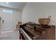 Entryway with piano, chair, and a view of the front door at 7516 Cypress Walk Dr, New Port Richey, FL 34655