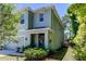 Two-story house with light blue siding and front landscaping at 7516 Cypress Walk Dr, New Port Richey, FL 34655