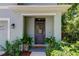 Inviting front door entrance with decorative basket and potted plants at 7516 Cypress Walk Dr, New Port Richey, FL 34655