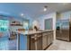 Kitchen island with granite countertop, stainless steel dishwasher, and view into dining area at 7516 Cypress Walk Dr, New Port Richey, FL 34655