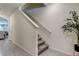 Staircase with grey carpeting and a view of living area at 7516 Cypress Walk Dr, New Port Richey, FL 34655