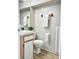 Clean bathroom with light wood vanity and tile flooring at 3615 Wellington Dr, Holiday, FL 34691