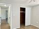Bedroom with sliding door closet and view of hallway at 3615 Wellington Dr, Holiday, FL 34691