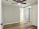 Spacious bedroom with wood-look floors and ceiling fan at 3615 Wellington Dr, Holiday, FL 34691