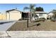 Ranch-style home with attached garage and a well-maintained lawn at 3615 Wellington Dr, Holiday, FL 34691