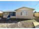 Rear view of house showcasing tan and gray siding at 3615 Wellington Dr, Holiday, FL 34691