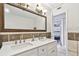 Elegant bathroom with a double vanity and large mirror at 1508 Delaware Ne Ave, St Petersburg, FL 33703