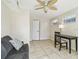 Bright bonus room with a desk, couch, and access to a patio at 1508 Delaware Ne Ave, St Petersburg, FL 33703