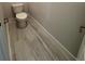 Simple half bathroom with grey tile floor at 1574 Running Tide Pl, Sarasota, FL 34240