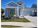 Two-story home with light blue siding, white garage door, and landscaping at 1574 Running Tide Pl, Sarasota, FL 34240