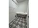 Laundry room with patterned floor and shelving at 1574 Running Tide Pl, Sarasota, FL 34240