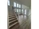 Modern staircase with black metal railings and hardwood treads at 1574 Running Tide Pl, Sarasota, FL 34240