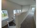 Upstairs hallway with carpet and natural light at 1574 Running Tide Pl, Sarasota, FL 34240