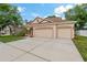 House exterior showcasing a three-car garage and curb appeal at 12814 Cattail Shore Ln, Riverview, FL 33579