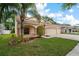 House exterior with landscaped lawn and two-car garage at 12814 Cattail Shore Ln, Riverview, FL 33579