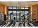 Well-equipped gym with modern exercise machines and a view of the pool at 1007 Emerald Dunes Dr, Sun City Center, FL 33573