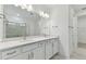 Double vanity bathroom with white cabinets and quartz countertops at 9305 Barnacle Ln, Parrish, FL 34219