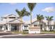 Inviting Clubhouse entrance with palm trees and landscaping at 9305 Barnacle Ln, Parrish, FL 34219