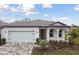 One-story home with a light-colored exterior, a paved driveway, and landscaping at 9305 Barnacle Ln, Parrish, FL 34219