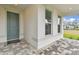 Charming front porch with a gray door and a brick-paved walkway at 9305 Barnacle Ln, Parrish, FL 34219