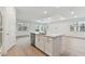 Kitchen island with white shaker cabinets and quartz countertops at 9305 Barnacle Ln, Parrish, FL 34219